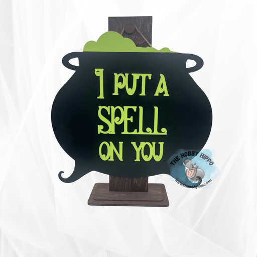 Laser cut wooden wall or door hanger, featuring a cauldron with bubbly brew, and the words “I put a spell on you”, Halloween decoration 