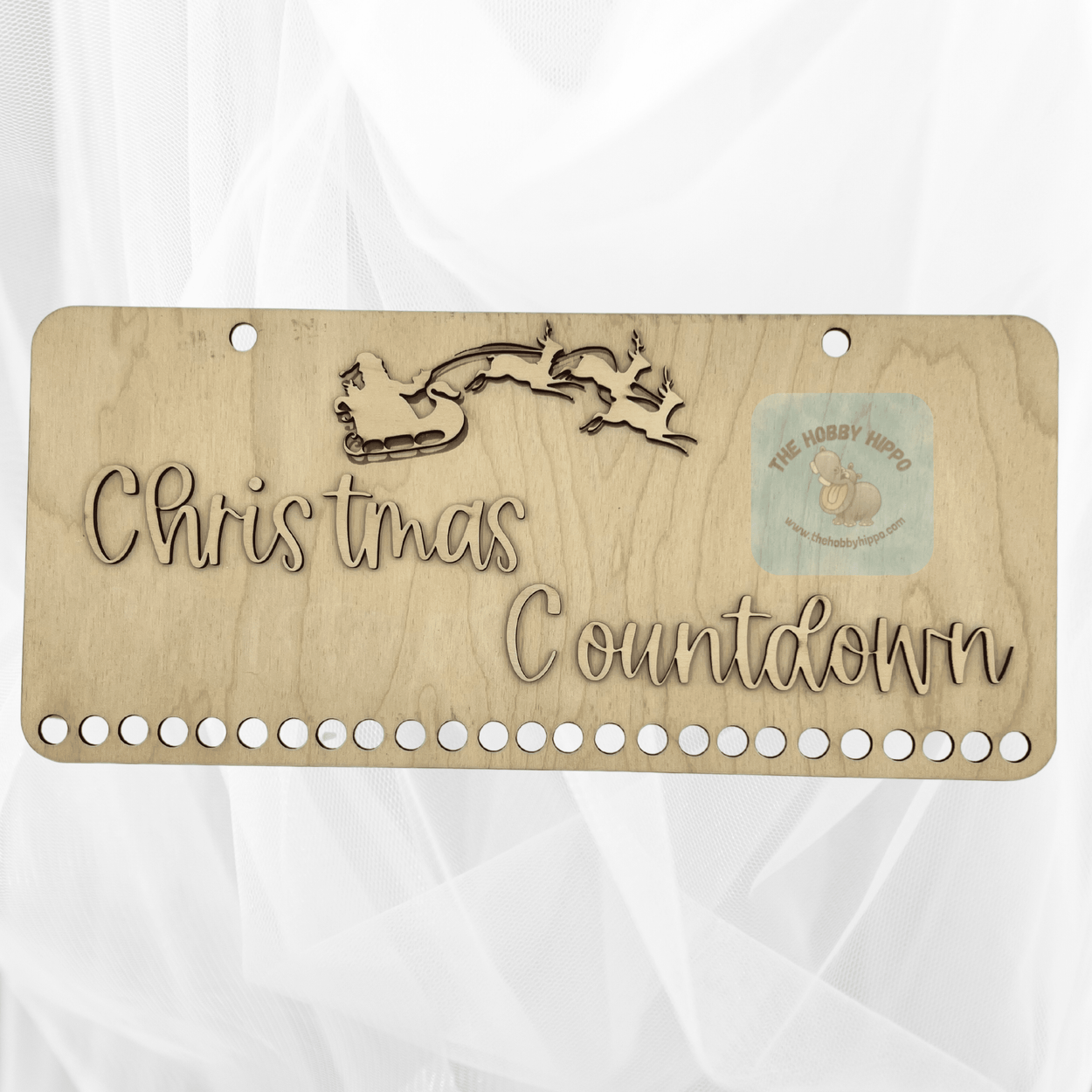 A wooden plaque saying “Christmas Countdown” with a Santa and reindeer at the top. DIY paint or stain to your preference. Had 25 holes at the bottom to hang candy canes and each day you remove a candy cane and when they are all gone it is Christmas Day! 