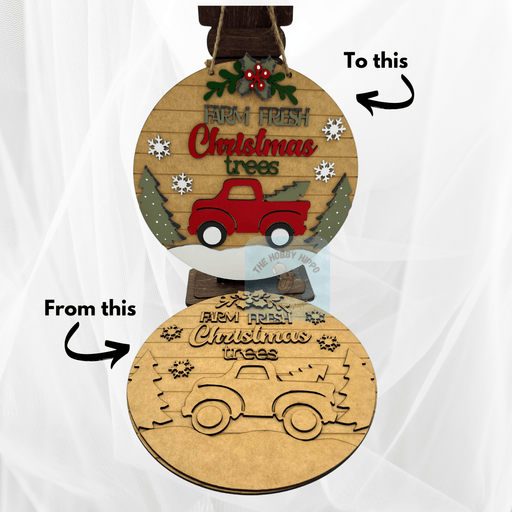 A round wooden wall or door hanger for holiday decor, DIY kit, featuring a truck and the words "Farm Fresh Christmas Trees". Top picture is for inspiration and bottom is the raw wood DIY