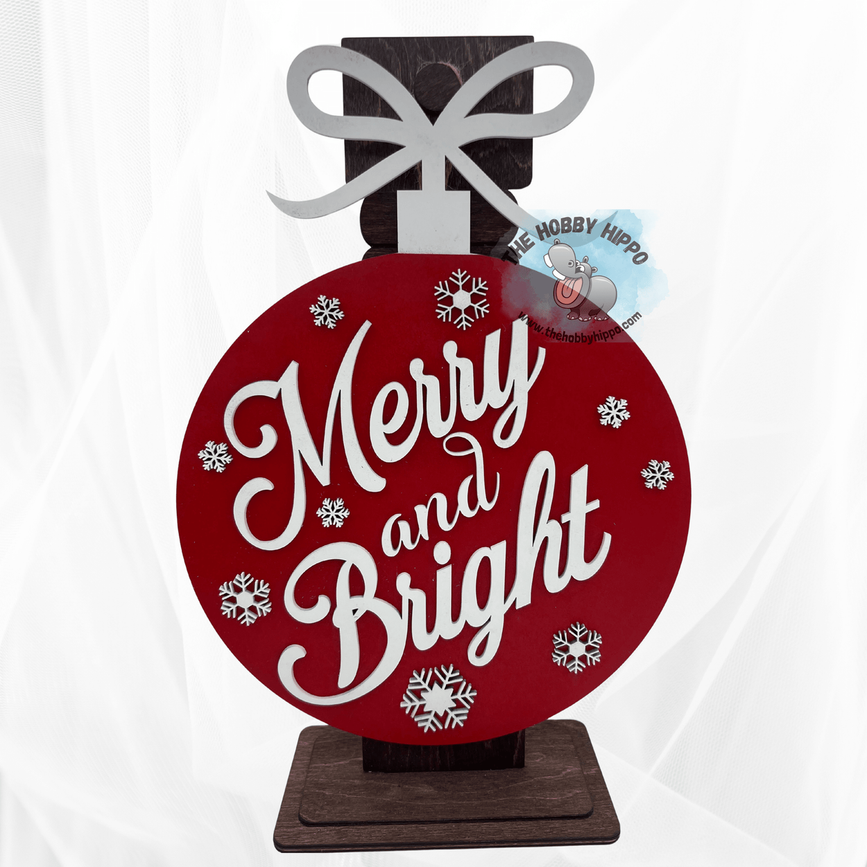 An inspiration picture of the wooden wall or door hanger shaped like a Christmas tree ornament with the words "Merry and Bright"