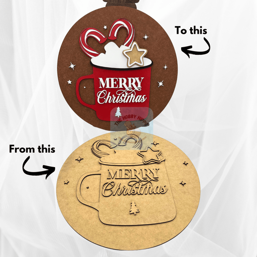 A cheerful "Merry Christmas" sign in a mug shape on a round background. Part of a DIY paint kit for holiday decor