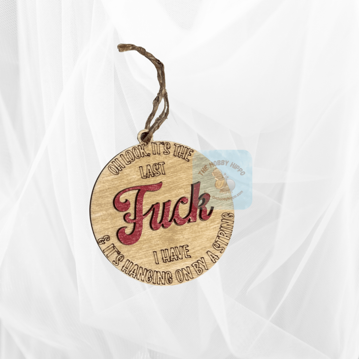 Wooden round Christmas ornament with the saying "Oh look it's the last Fuck I have & it's hanging by a string", Lightly stained and the word "Fuck" is painted red, 