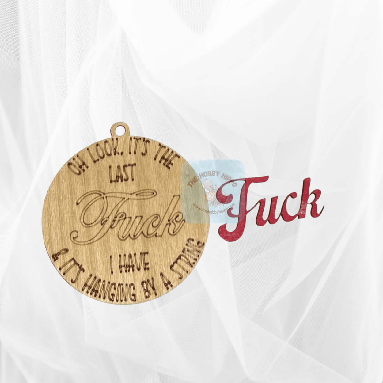 Round wooden Christmas ornament, featuring the saying "Oh look it's the last Fuck I have & it's hanging by a sting", Fuck is laser cut separately to give it a 3d effect