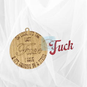 Round wooden Christmas ornament, featuring the saying "Oh look it's the last Fuck I have & it's hanging by a sting", Fuck is laser cut separately to give it a 3d effect