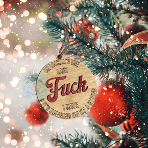 The Last Fuck I Have Christmas ornament, wooden round lightly stained and the naughty word painted red